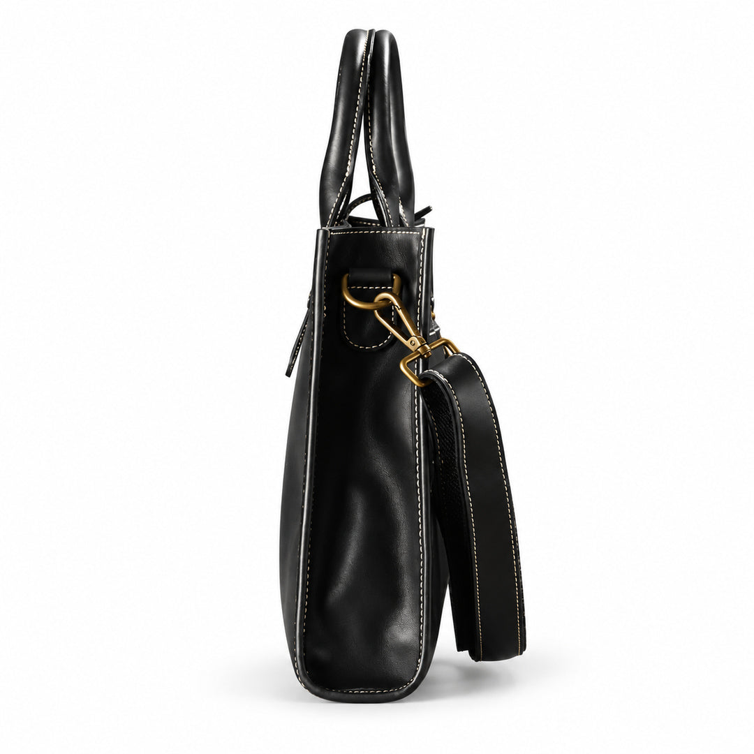 Men's black full-grain leather tote bag side view with a narrow gusset and detachable shoulder strap
