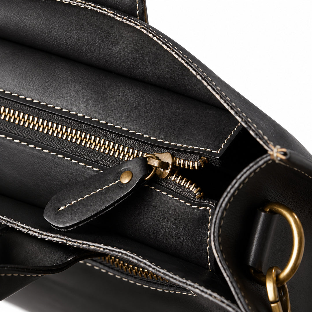 Men's black full-grain leather tote bag top zipper with a leather pull and contrast stitching