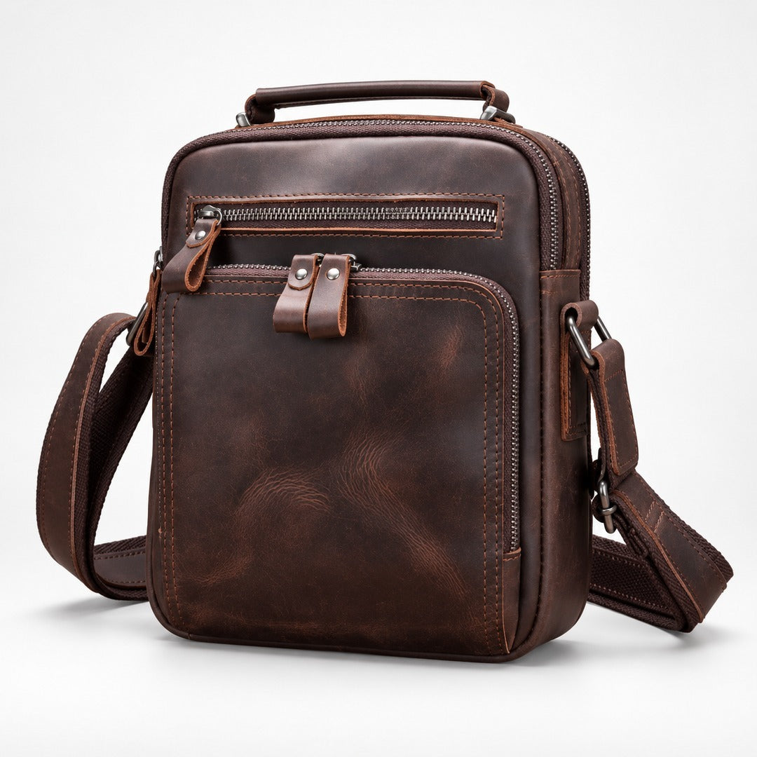 A dark brown distressed leather crossbody bag with multiple zippered compartments, a top handle, and an adjustable shoulder strap, shown on a light gray background.
