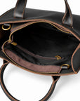 Minimalist black full-grain leather tote interior with a zip pocket and black fabric lining