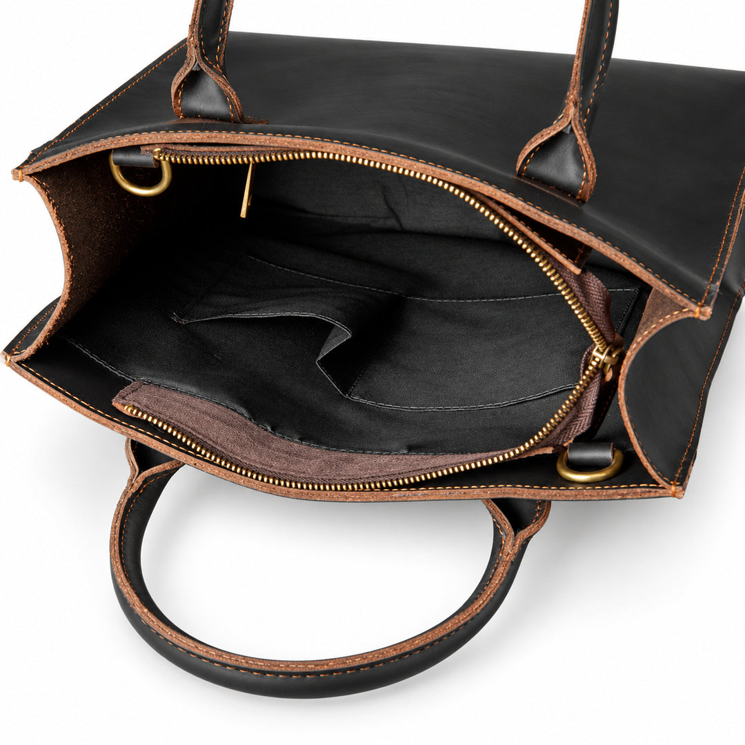 Minimalist black full-grain leather tote open interior with two slip pockets for small essentials