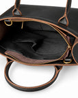 Minimalist black full-grain leather tote open interior with two slip pockets for small essentials