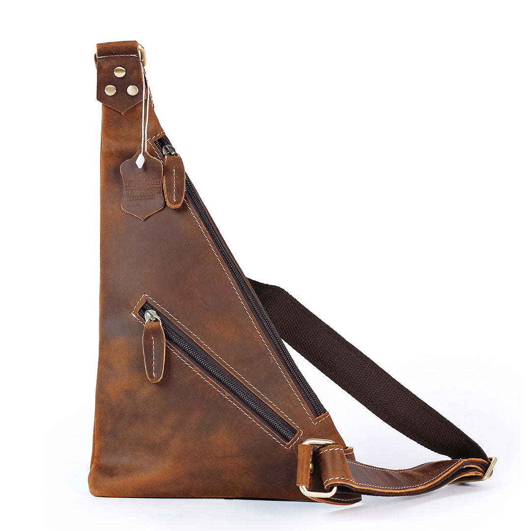 Brown leather sling bag with a strap on a white background
