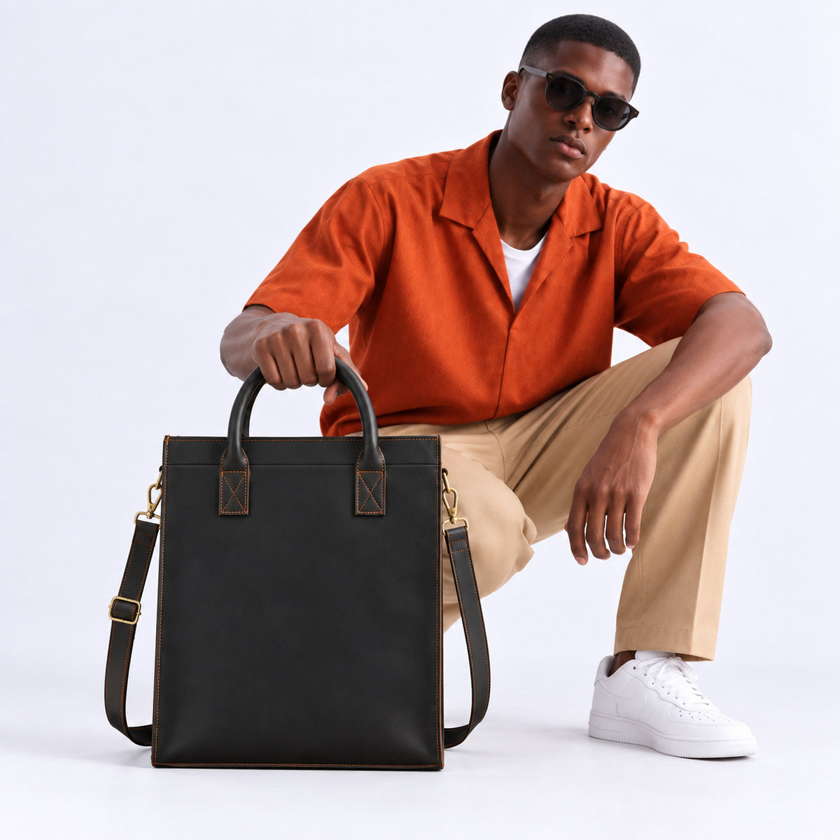 Modern black leather work tote for men with large vertical design, dual carry handles and adjustable shoulder strap