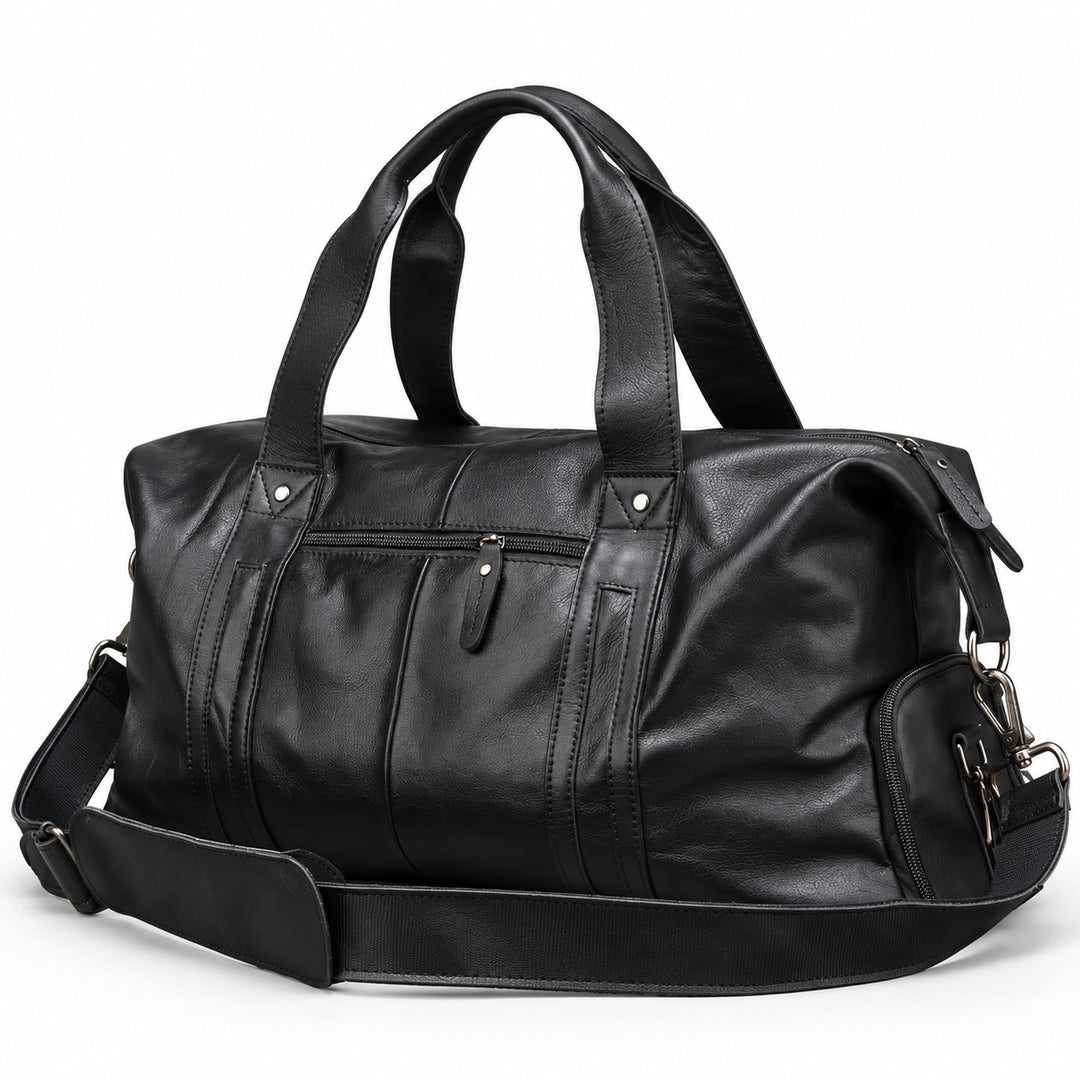 Modern black full-grain leather duffel bag at an angle showing the zippered side pocket.