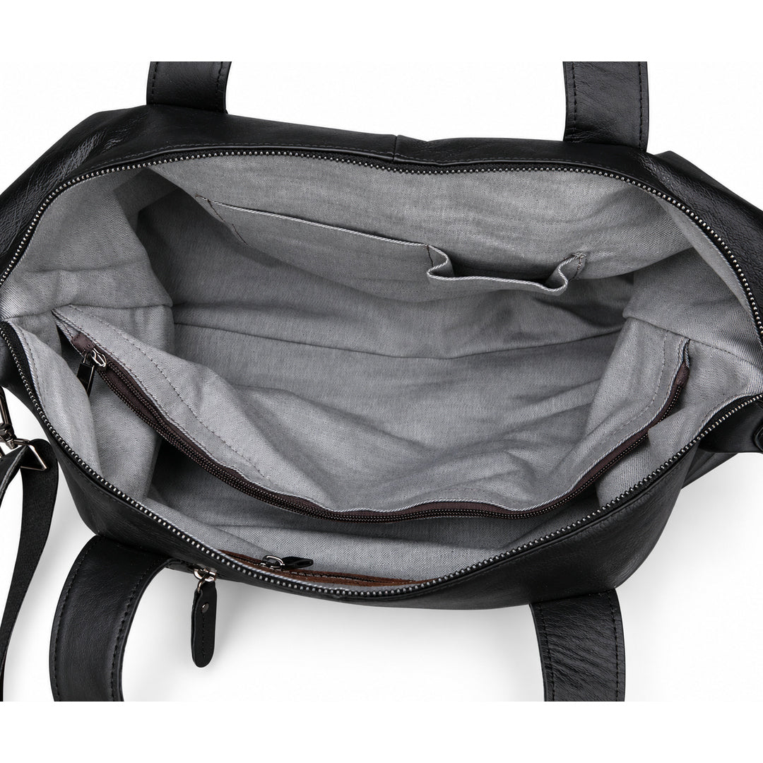 Modern black full-grain leather duffel bag interior with gray lining, slip pockets and a zip pocket.