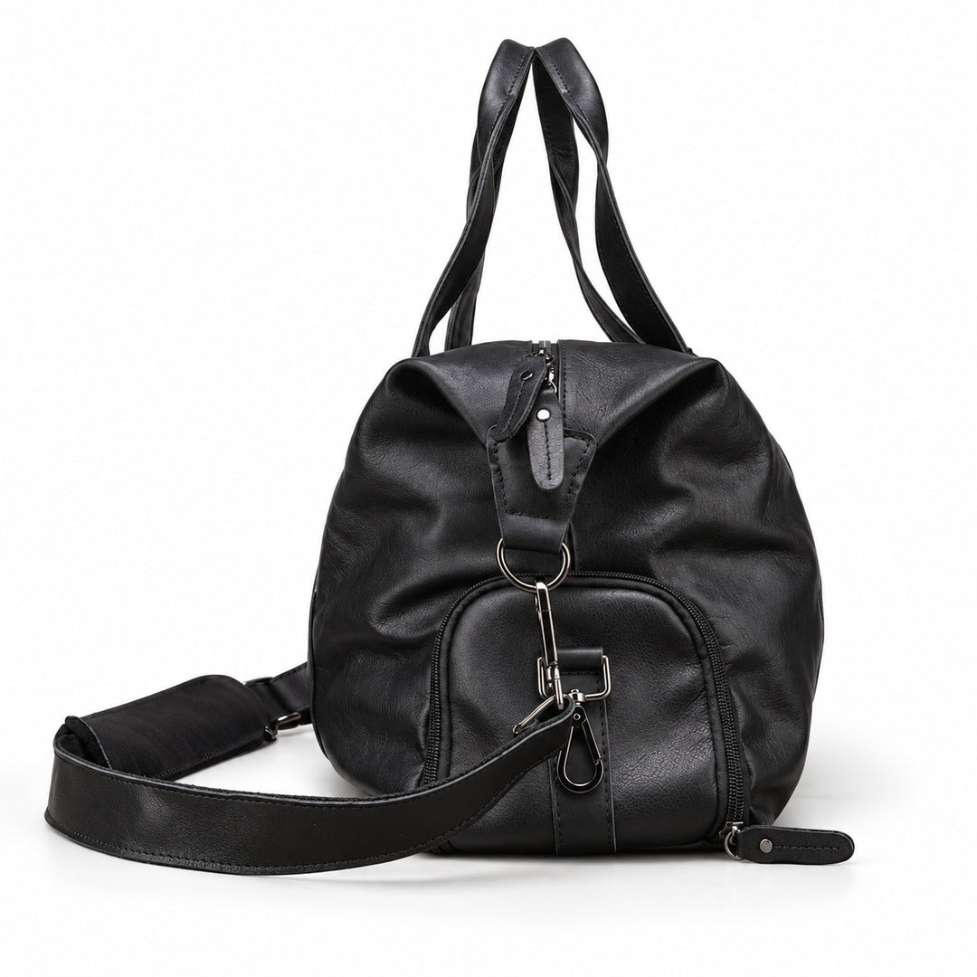 Modern black full-grain leather duffel bag side view with a rounded zip pocket and metal clips.