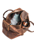 Open vintage crazy horse leather duffle bag from a top angle, highlighting its roomy interior and premium zipper details.