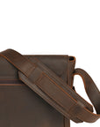 Sturdy padded shoulder strap of a brown leather satchel designed for comfortable everyday wear