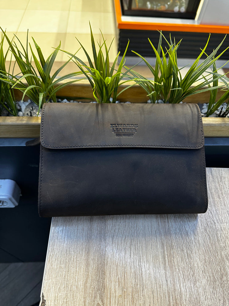 Premium leather wrist bag for men with smooth finish and modern style.