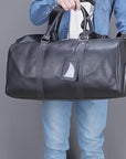 Men showing black leather duffel weekender bag with shoe compartment