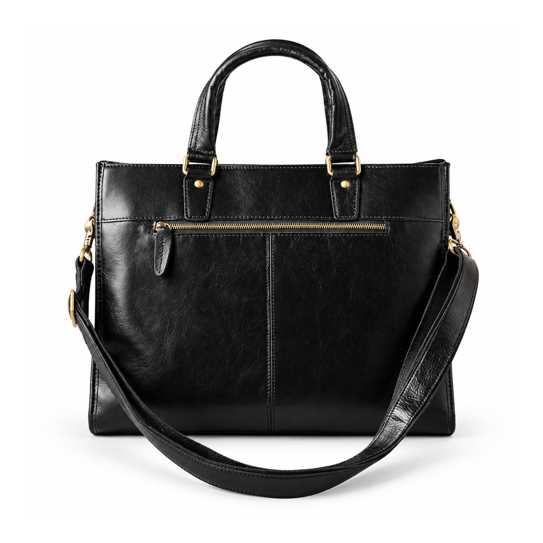 A black leather briefcase is shown from the back with a horizontal zip pocket, center seam and detachable shoulder strap.
