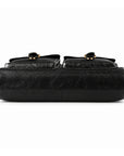 The bottom of a black leather briefcase shows a plain leather base, edge stitching and a central seam.