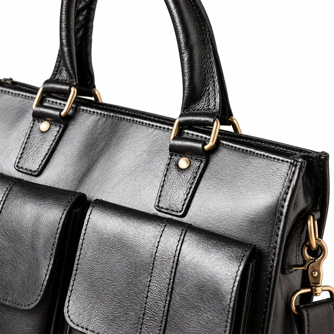 A close-up of the black leather briefcase shows rounded handles, brass-tone rings and riveted leather attachment tabs.