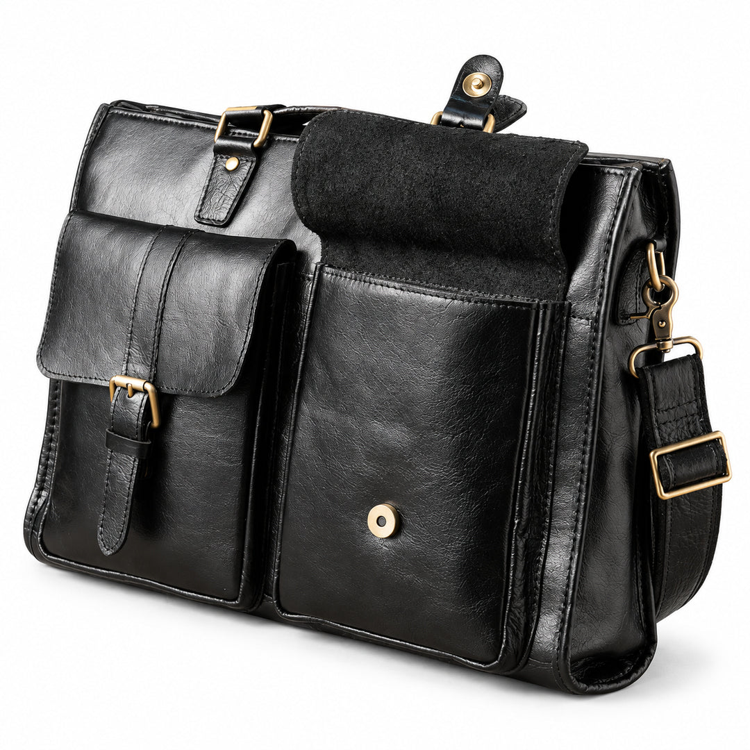 A black leather briefcase has one front flap pocket open, revealing its dark underside and round magnetic snap.