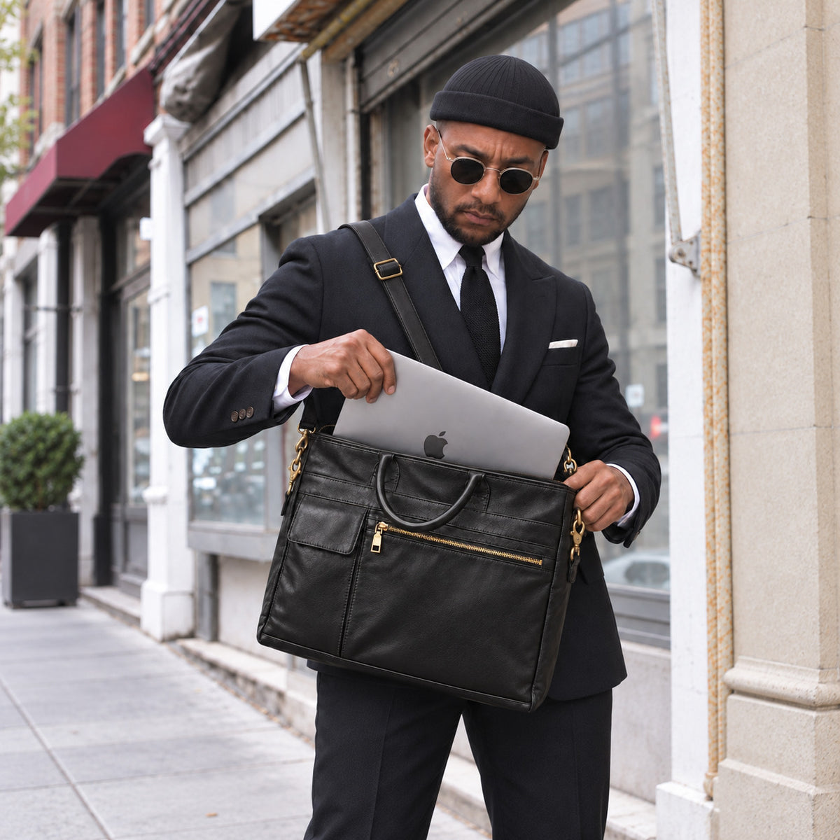 Professional black leather laptop bag for men with shoulder strap, top handles and spacious compartment for laptop and office essentials