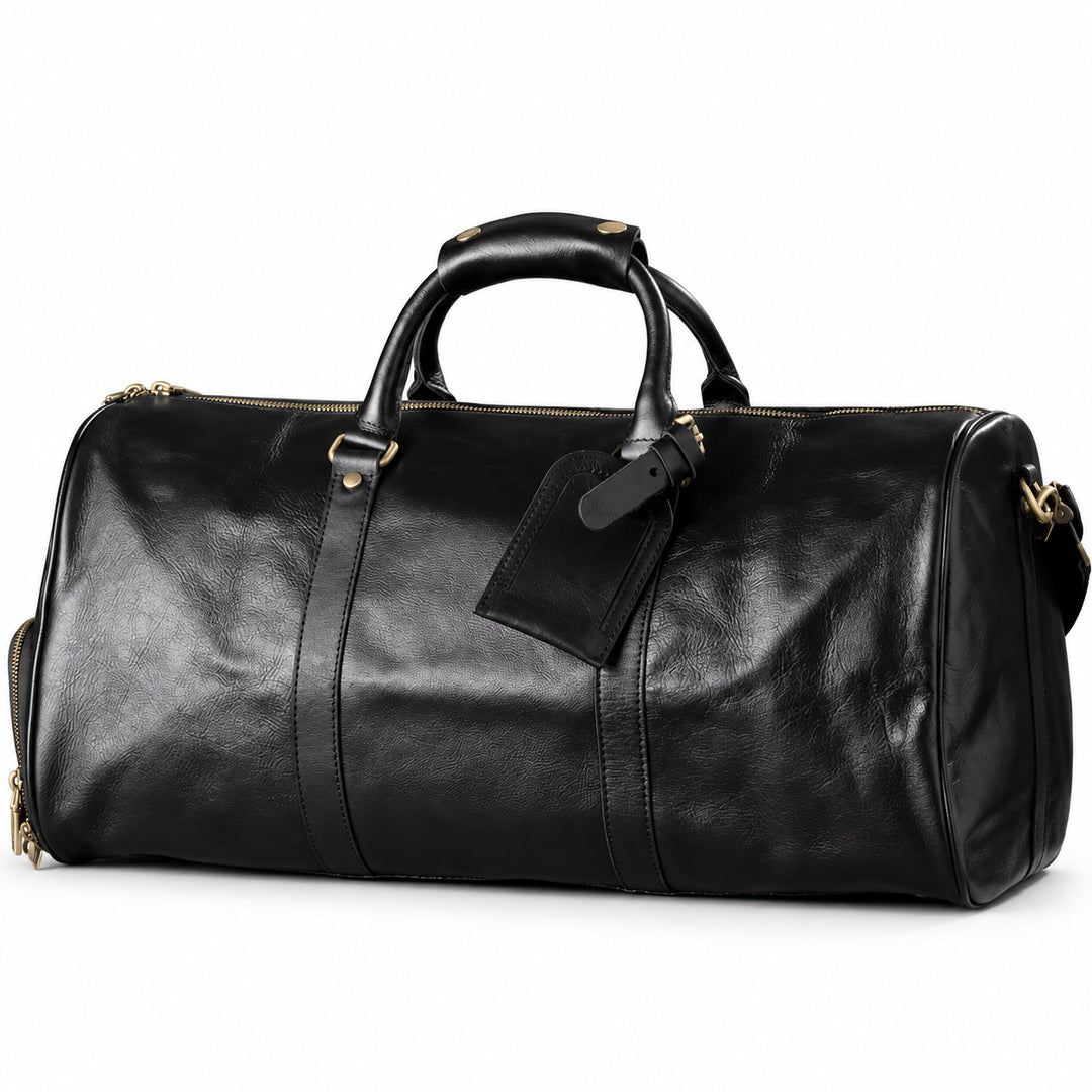 Refined black full-grain leather duffel bag at an angle showing its rounded end and leather trim