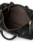 Refined black full-grain leather duffel bag open main compartment with brown fabric lining