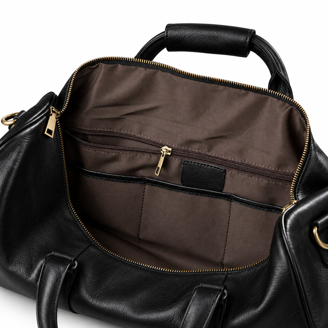 Refined black full-grain leather duffel bag interior with a zip pocket and brown fabric organizers