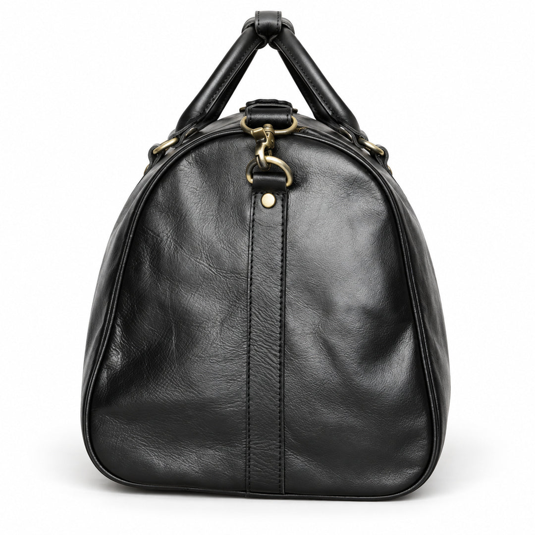 Refined black full-grain leather duffel bag side with leather piping and a detachable strap clasp