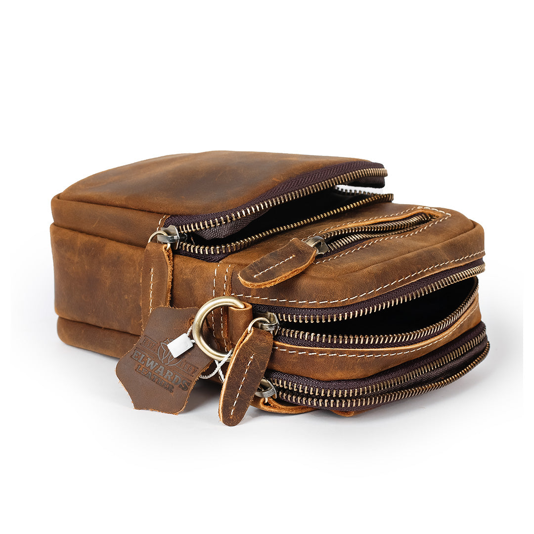 Brown leather bag with multiple zippers on a white background