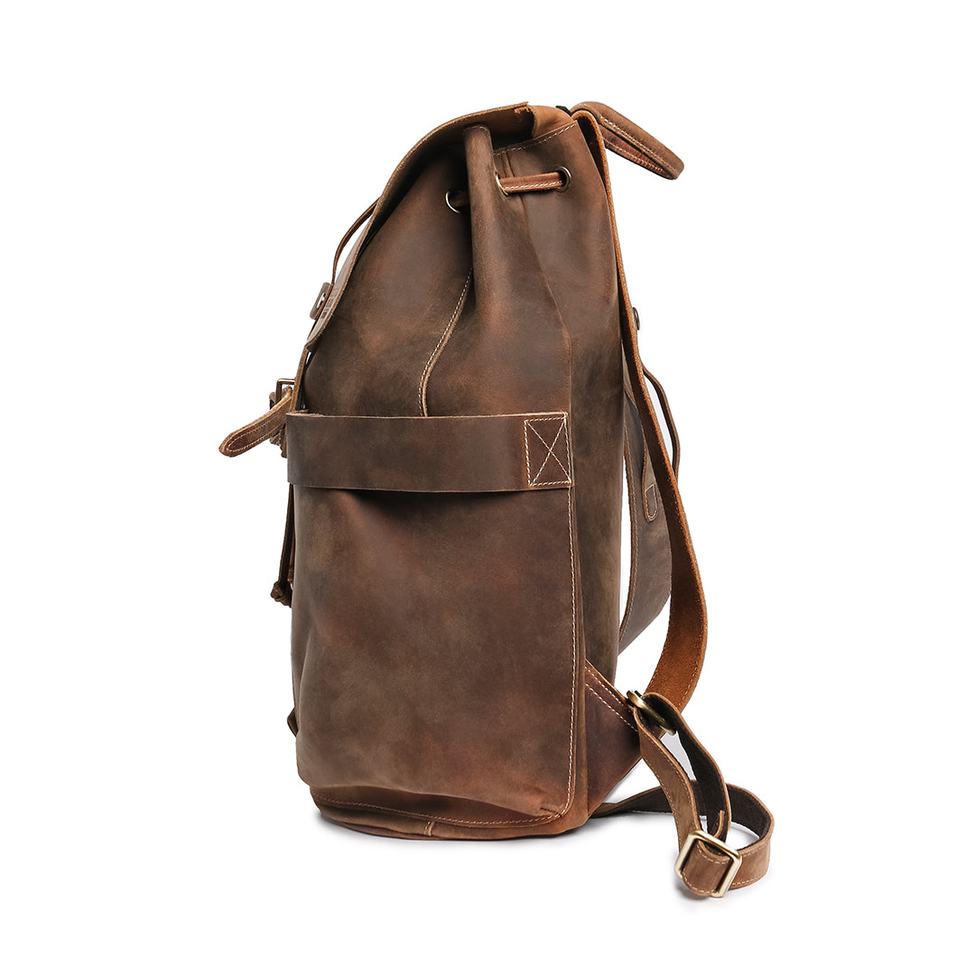 Close-up of a brown Crazy Horse leather backpack side pocket highlighting stitching details and easy-access design.