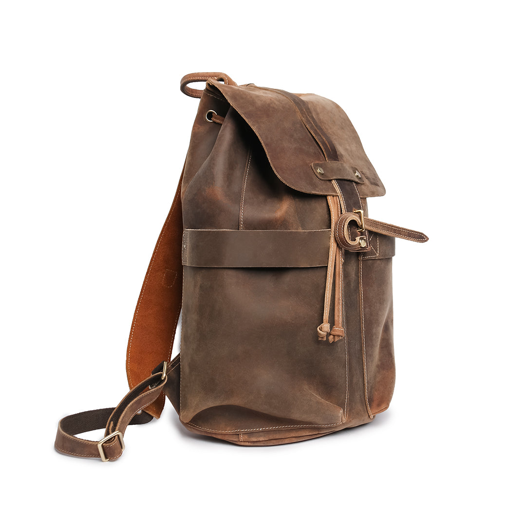 Close-up of a brown Crazy Horse leather backpack showcasing pocket and stitching details