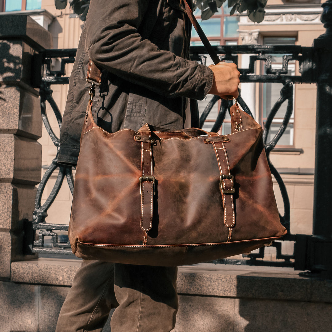 Side view of a vintage travel duffle bag, featuring durable Crazy Horse leather and spacious design for travel.