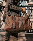 Side view of a vintage travel duffle bag, featuring durable Crazy Horse leather and spacious design for travel.