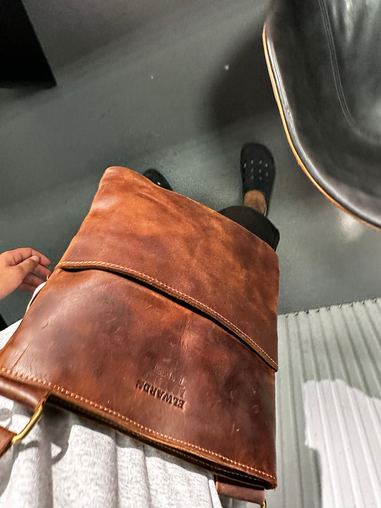 Sleek men's brown crossbody leather bag designed for comfort and style on the go.