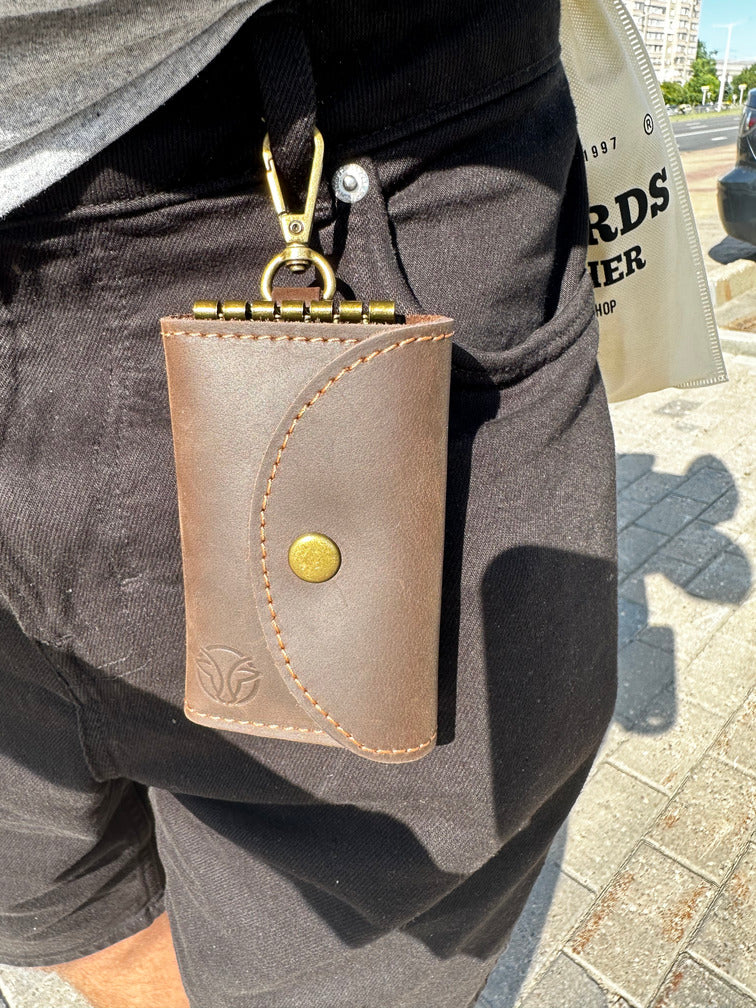 Small yet functional brown leather key case, great for everyday carry and key organization.