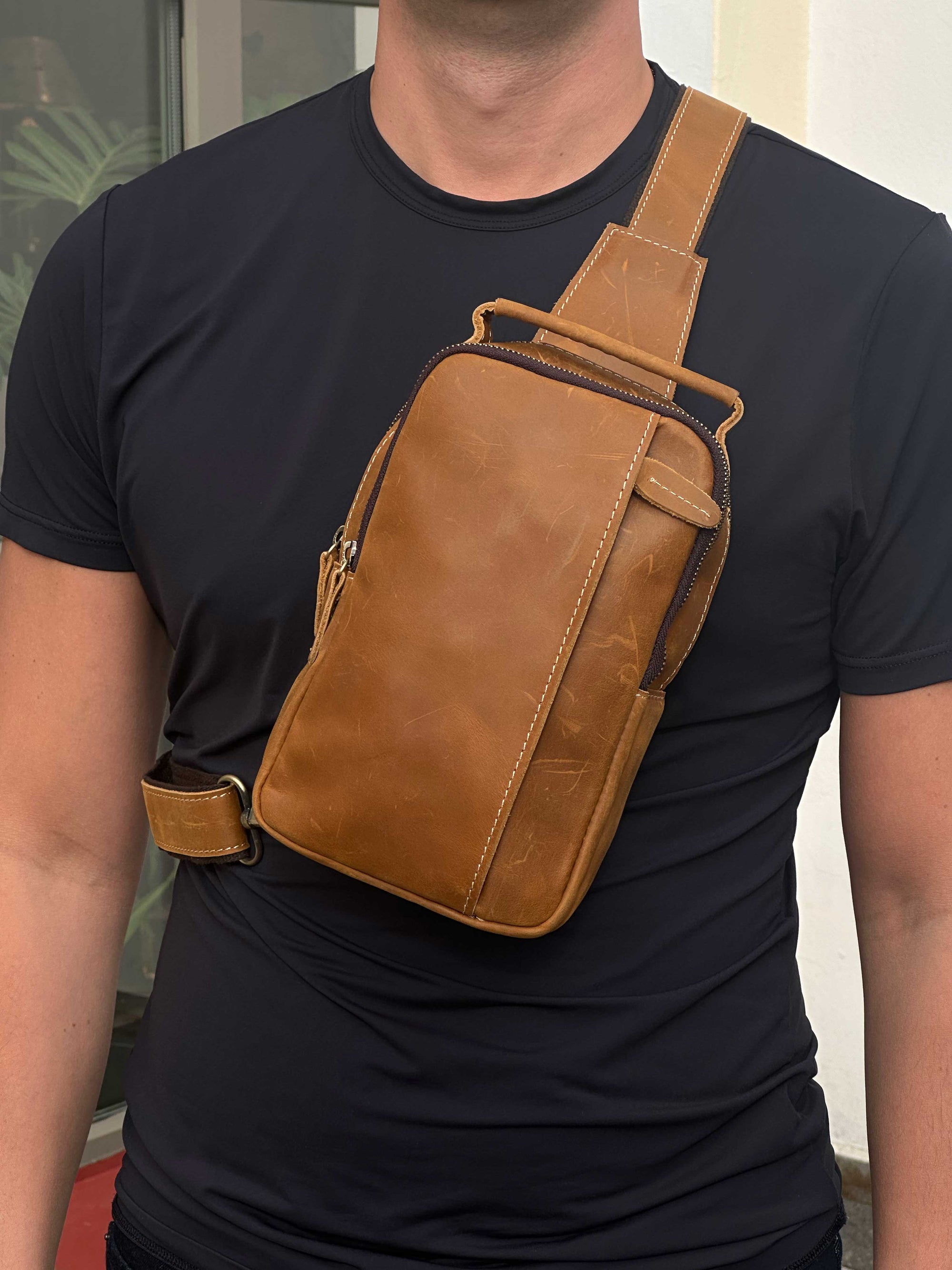 Tan leather crossbody sling bag for men, compact and stylish for everyday use