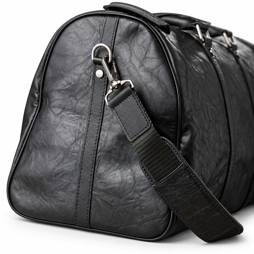 Textured black full-grain leather weekender bag strap with a silver-tone swivel clasp