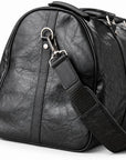 Textured black full-grain leather weekender bag strap with a silver-tone swivel clasp