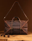 Front view of a vintage Crazy Horse leather duffle bag, handcrafted with adjustable strap and brass buckle details.