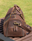 Side view of a vintage leather travel bag showcasing high-quality zippers and stitching details.